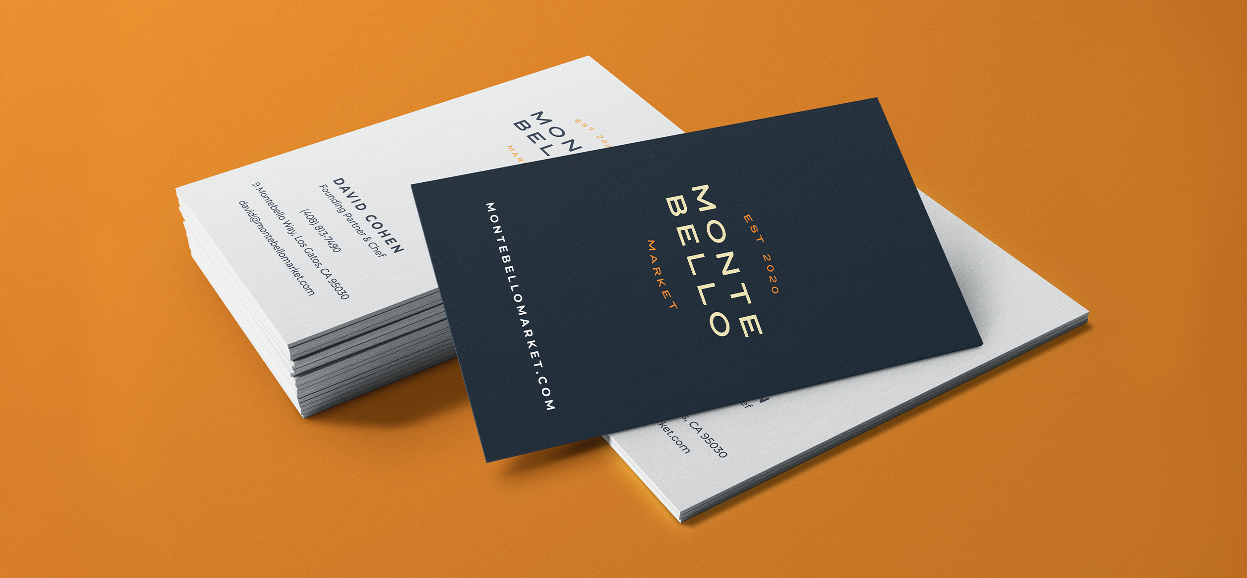 a stack of business cards with the Montebello logo