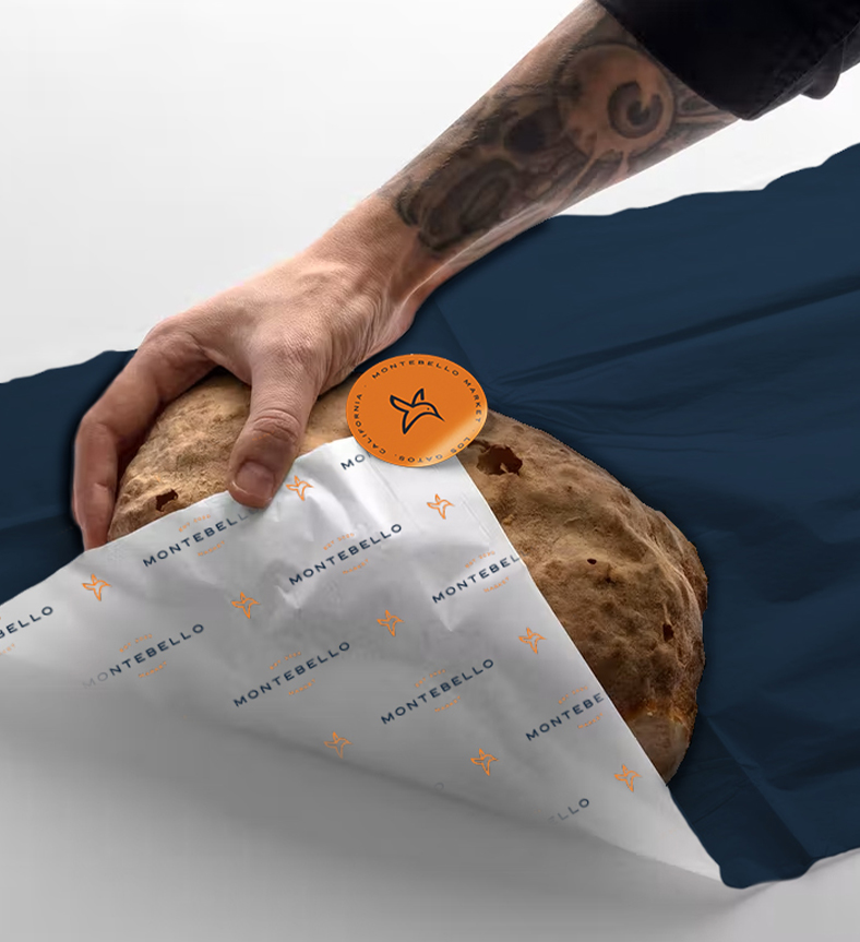 A loaf of bread wrapped in montebello branded paper
