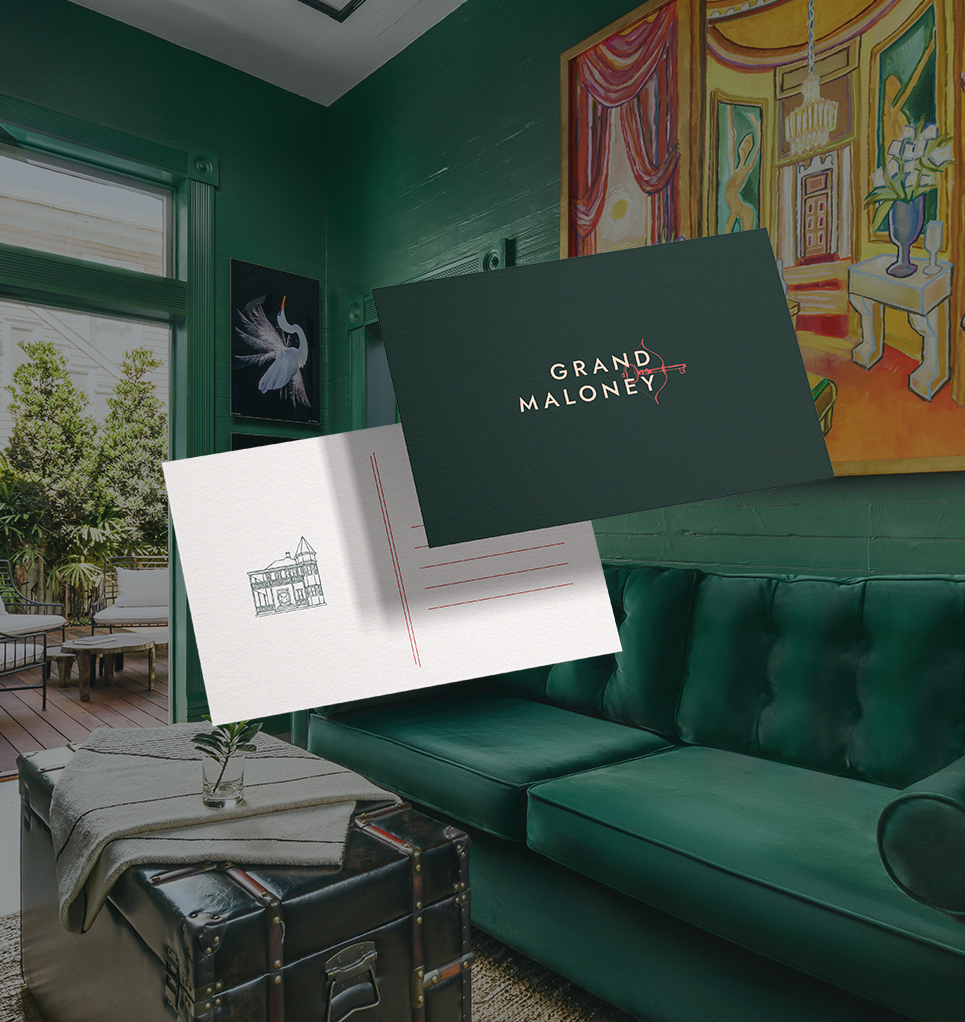 a green couch with a postcard and a trunk