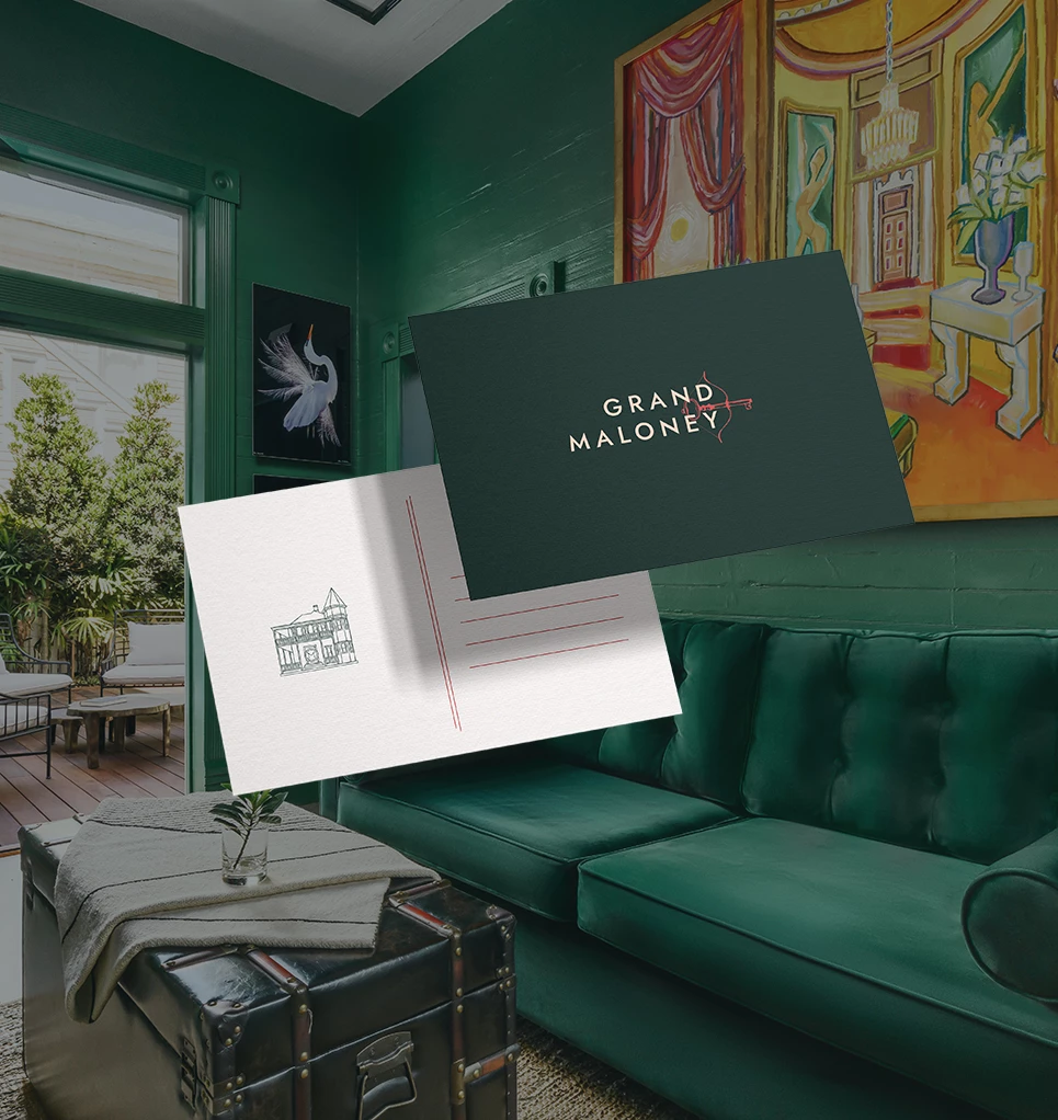a green couch with a postcard and a trunk