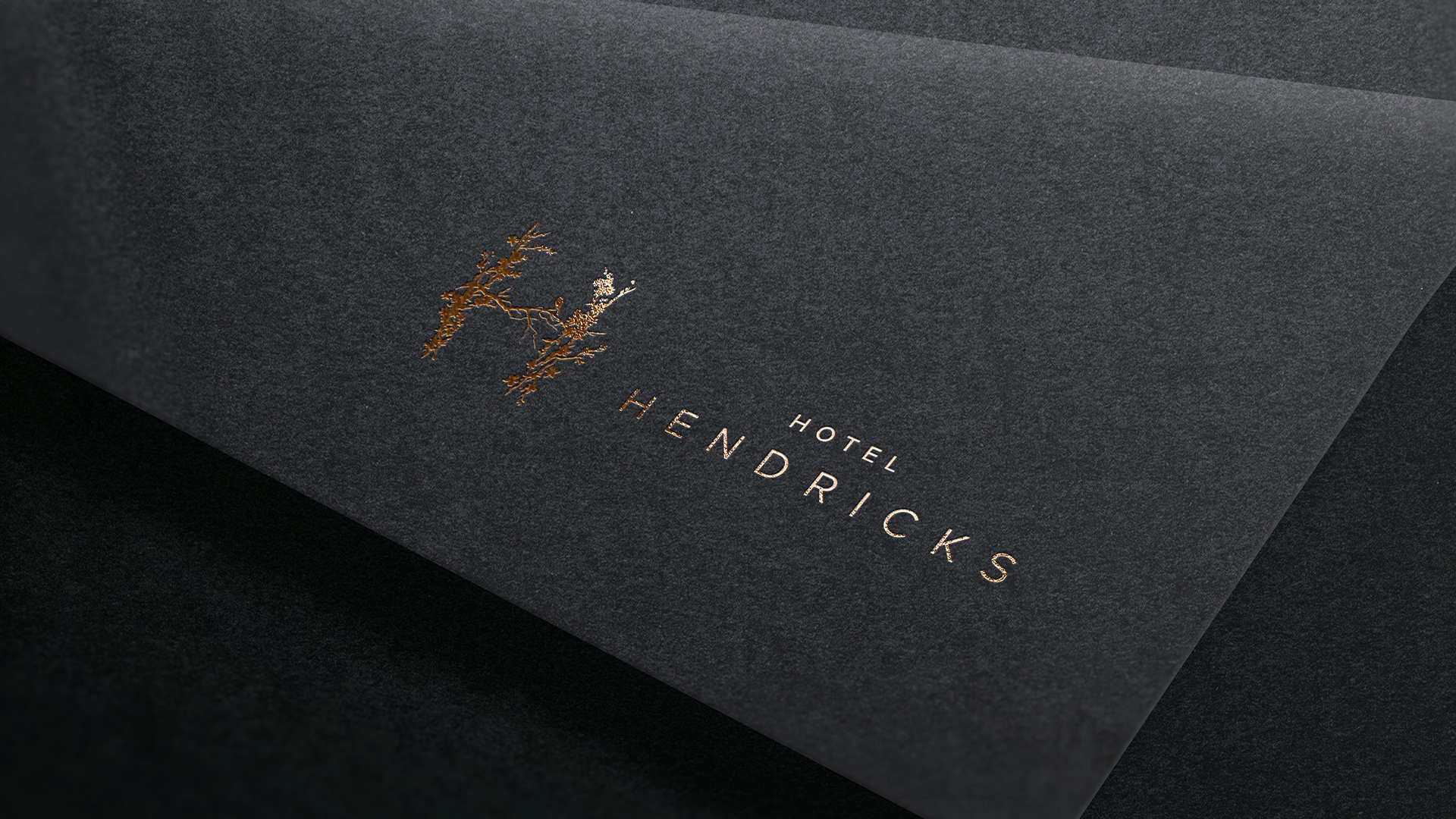 a black and gold logo on a black surface