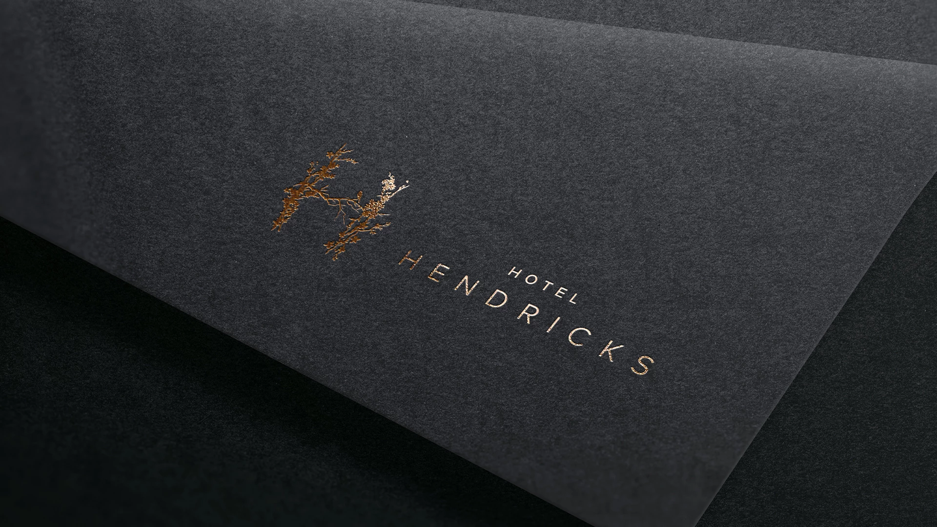 a black and gold logo on a black surface