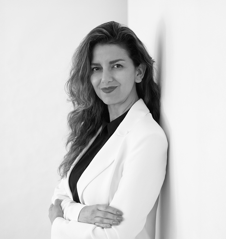 a woman leaning against a wall