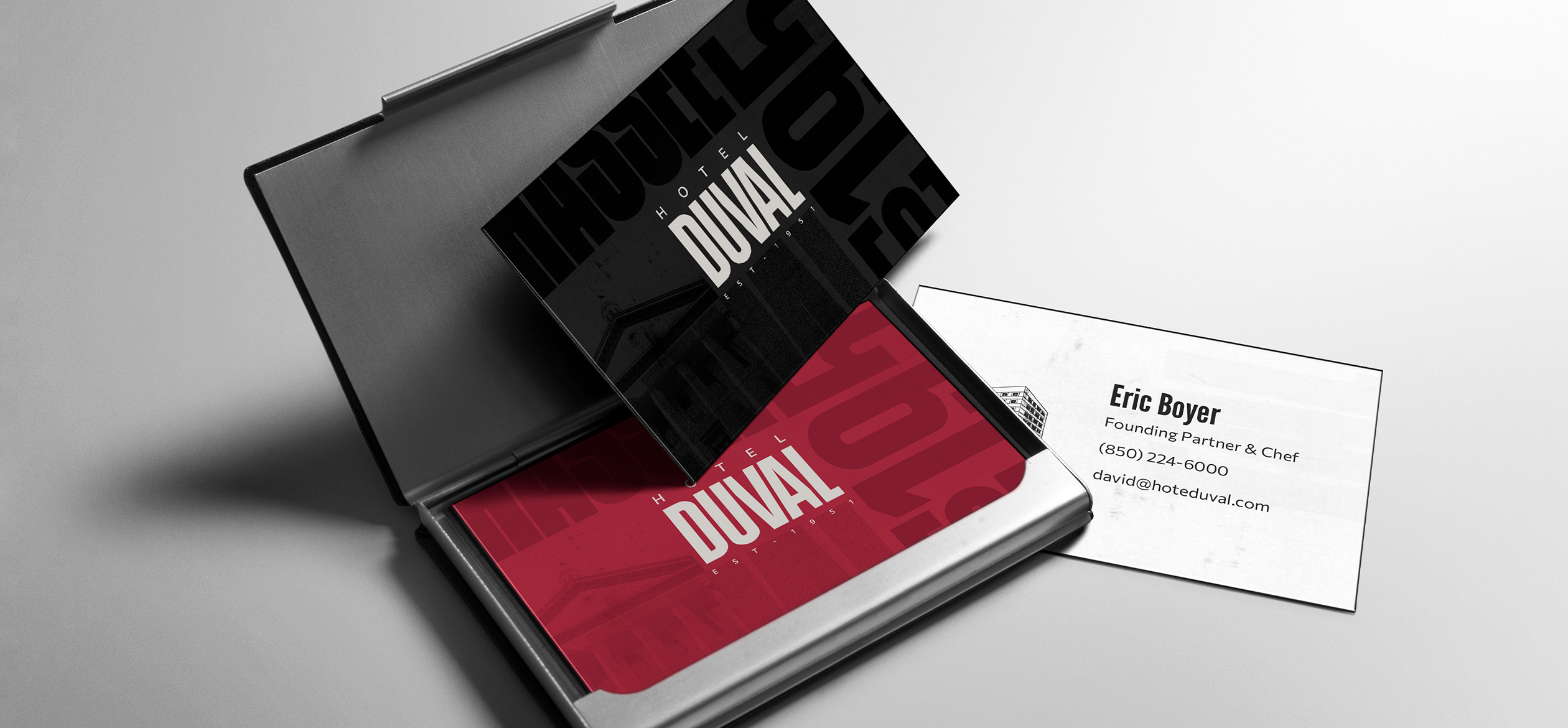 a black and red business card in a case