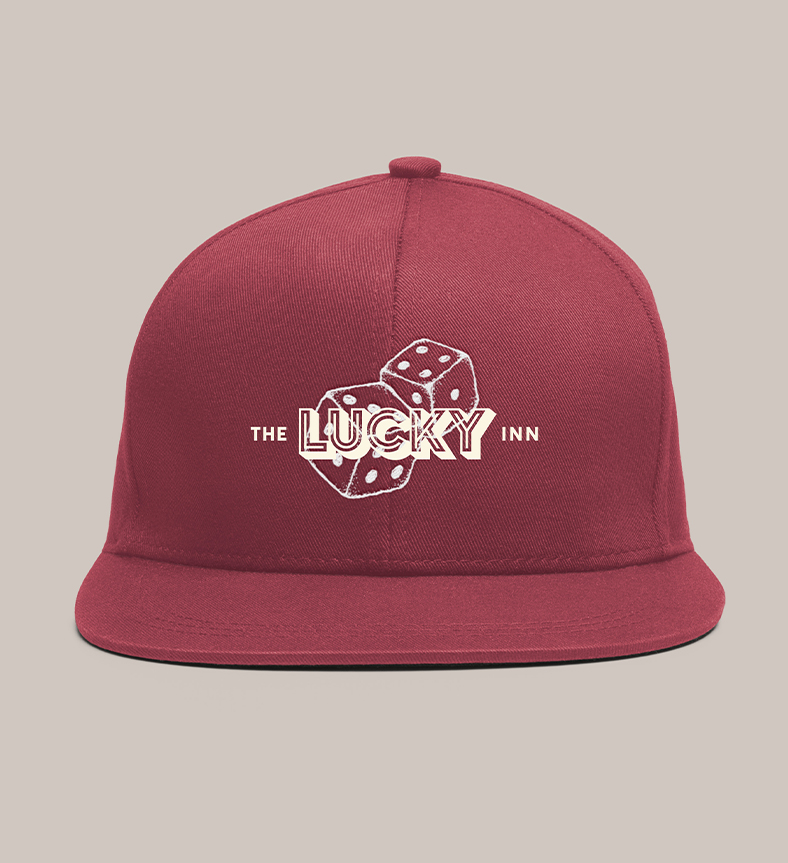 a red hat with die & The Lucky Inn logo on it