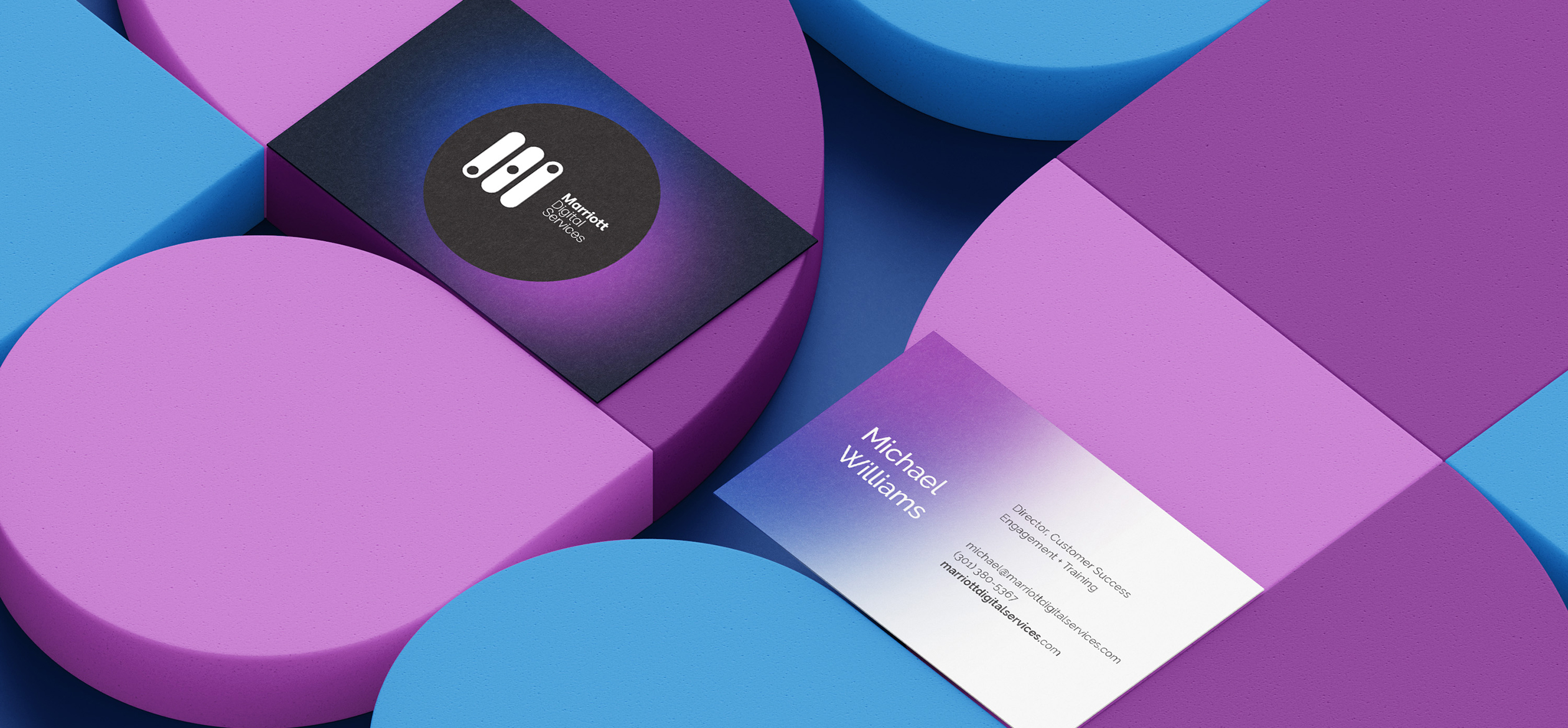 a group of colorful blocks with business cards in the middle that have Marriott Digital Services branding
