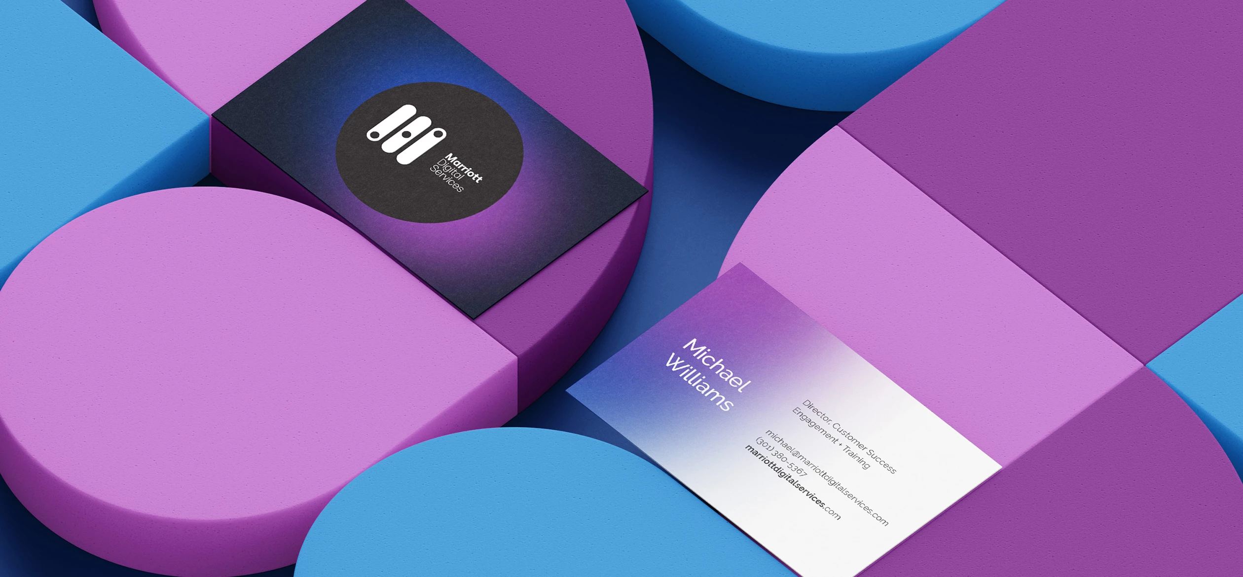 a group of colorful blocks with business cards in the middle that have Marriott Digital Services branding