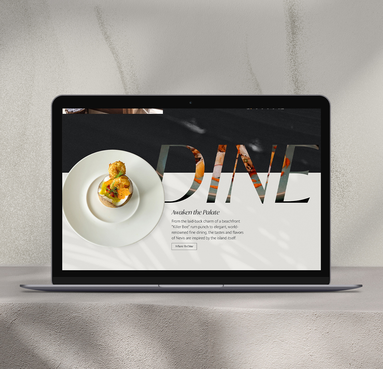 a laptop on a table that says "dine"