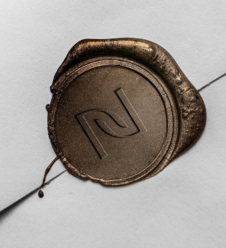 a wax seal on a white envelope with Nevis logo
