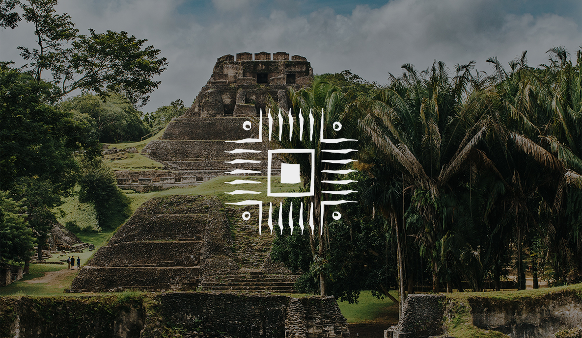 a group of ancient stone building ruins with trees and the prana maya logo