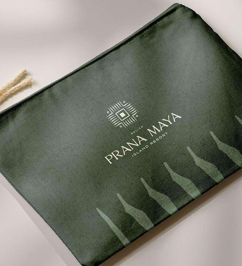 a green bag with white text and a prana maya logo on it