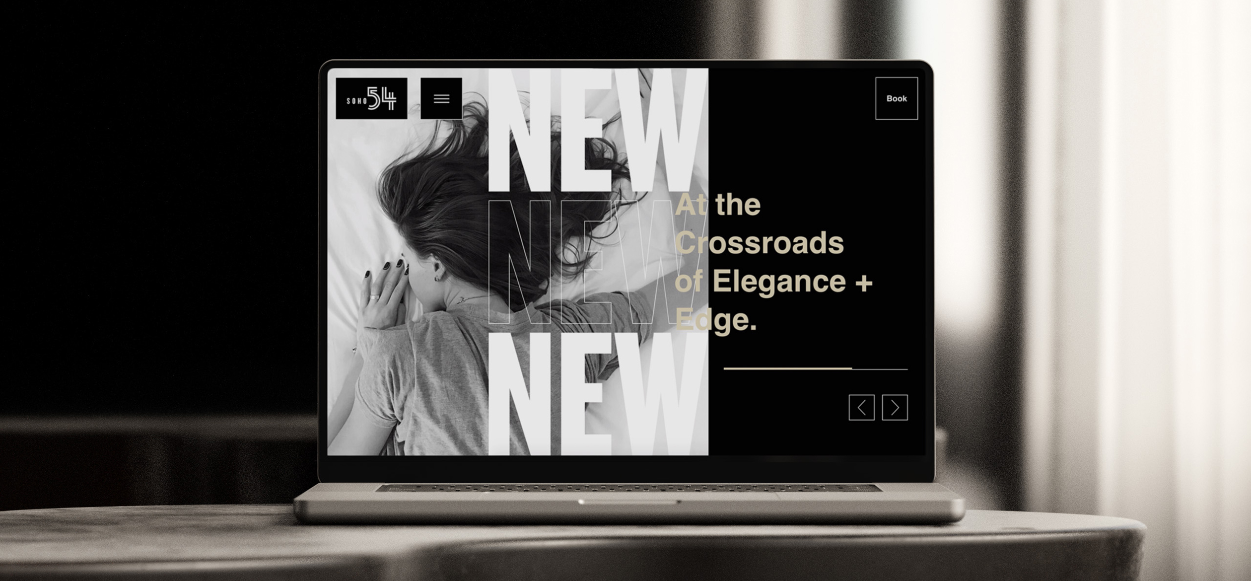 a laptop with a woman on it with the homepage of Soho 54 on it