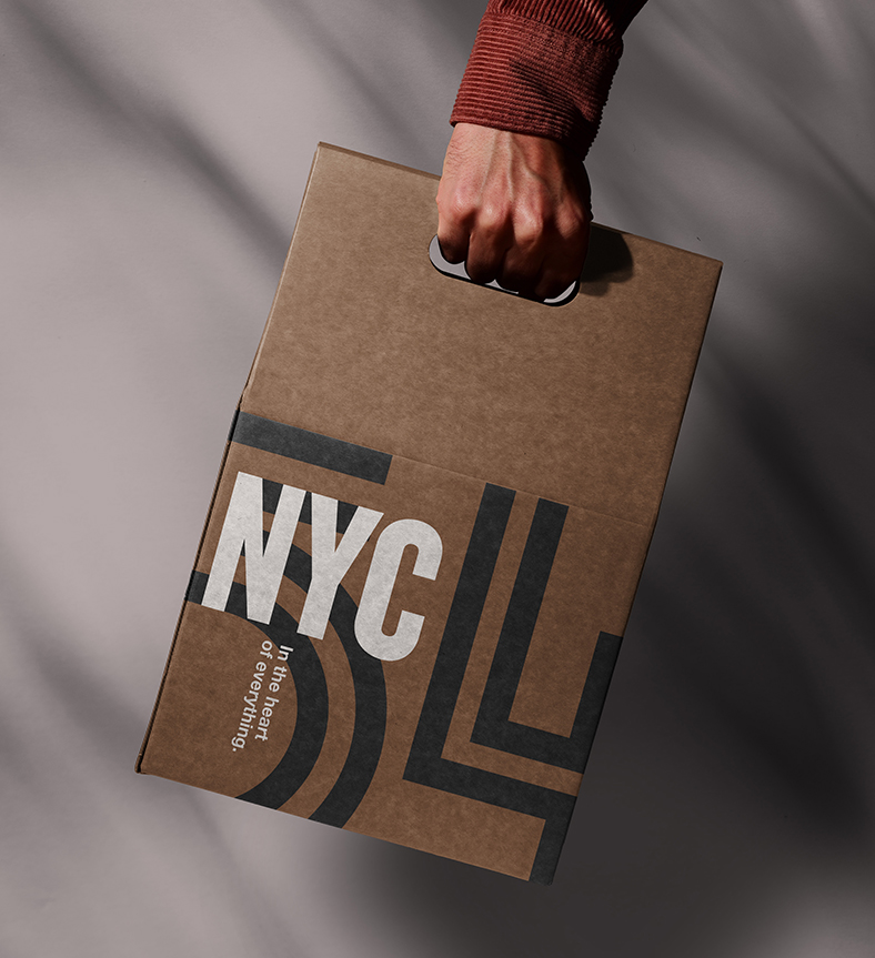 a hand holding a brown box with Soho 54 branding