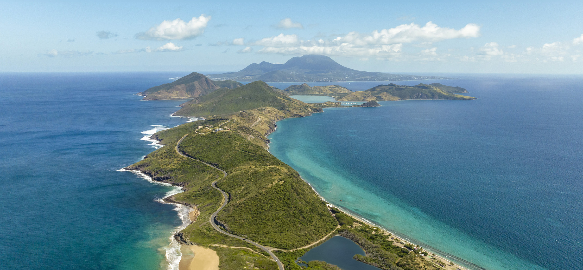 a aerial view of a road and lush green islands