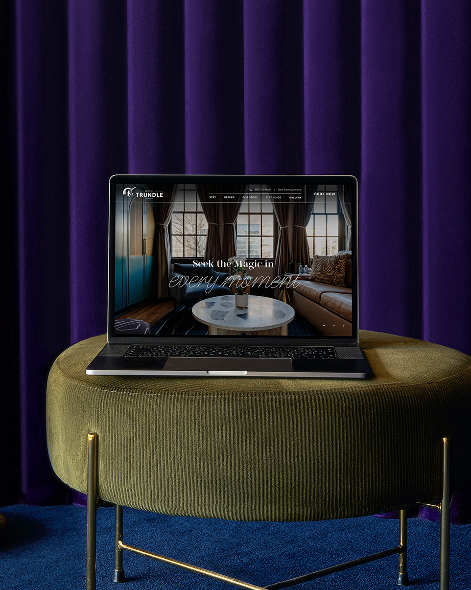 a laptop on a stool with an image of the trundle hotel on it