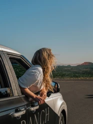 a woman looking out of a car window