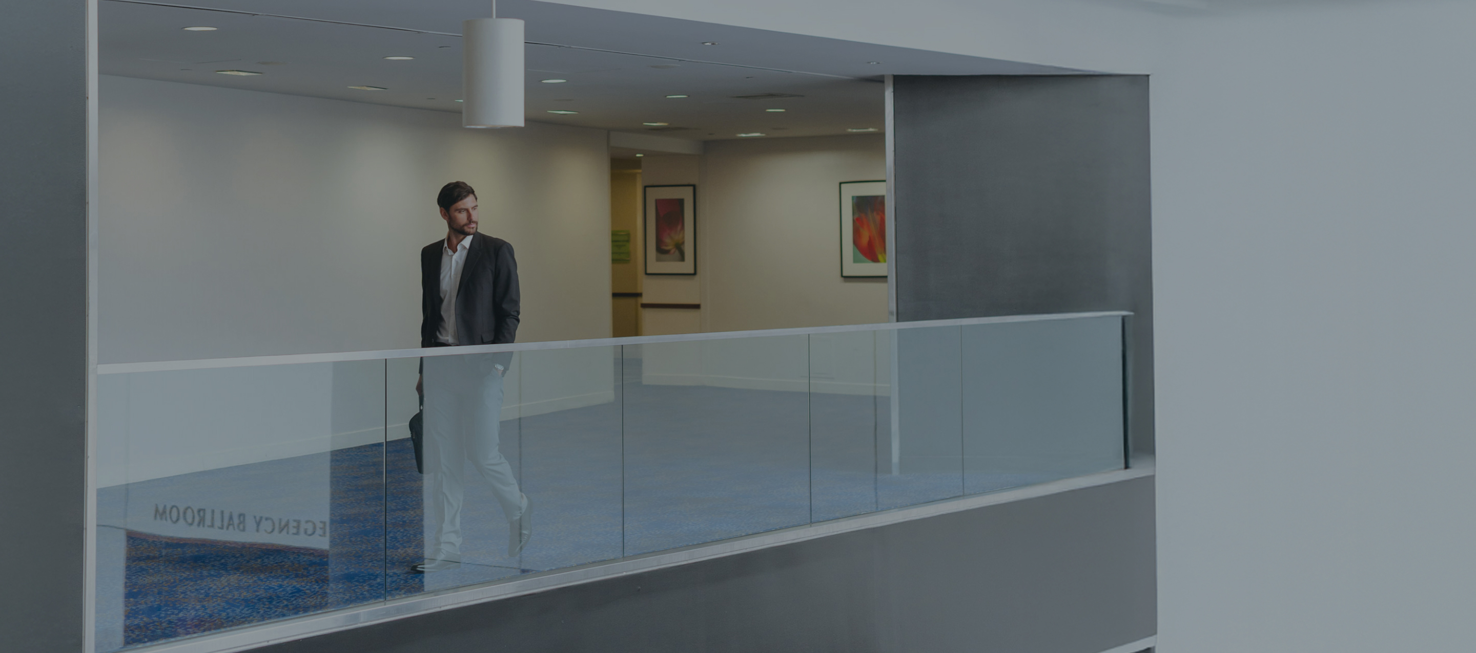 a man walking on a glass railing