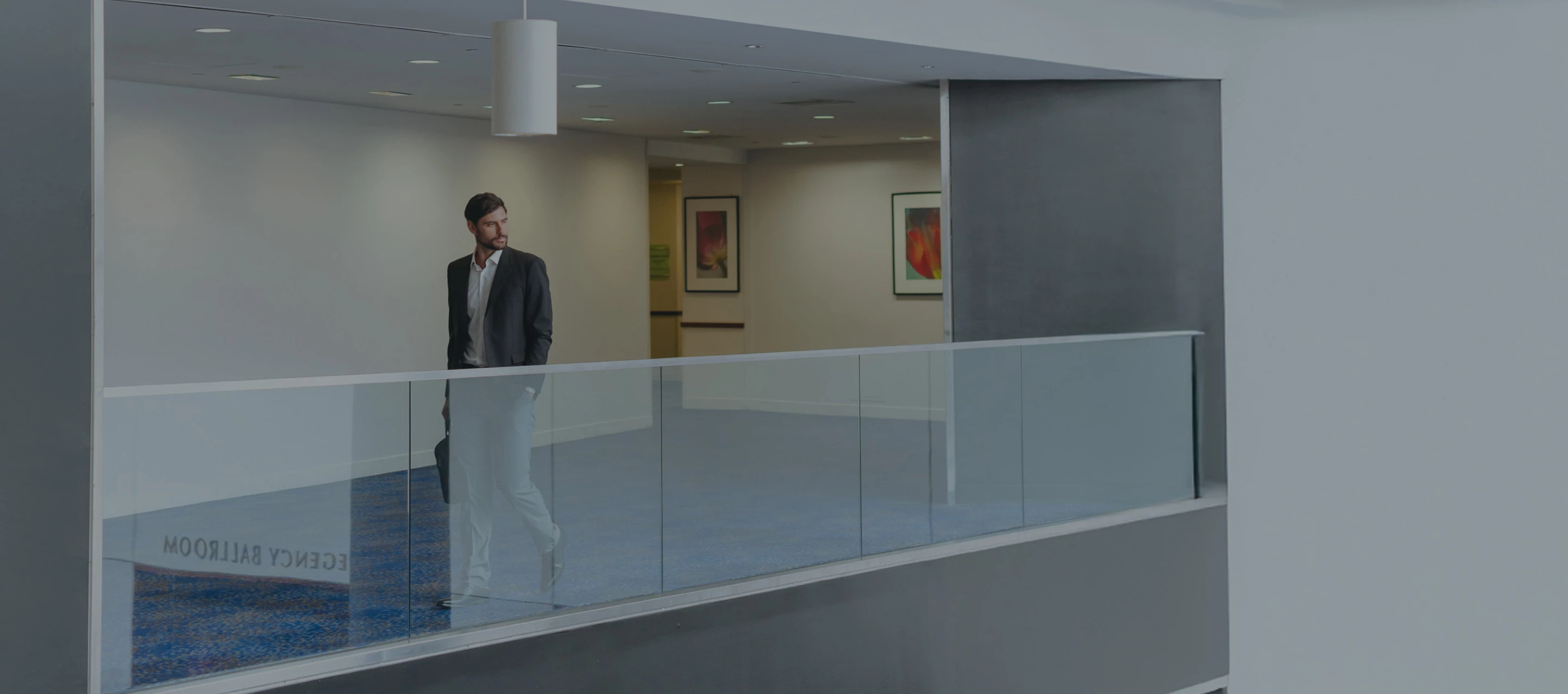 a man walking on a glass railing
