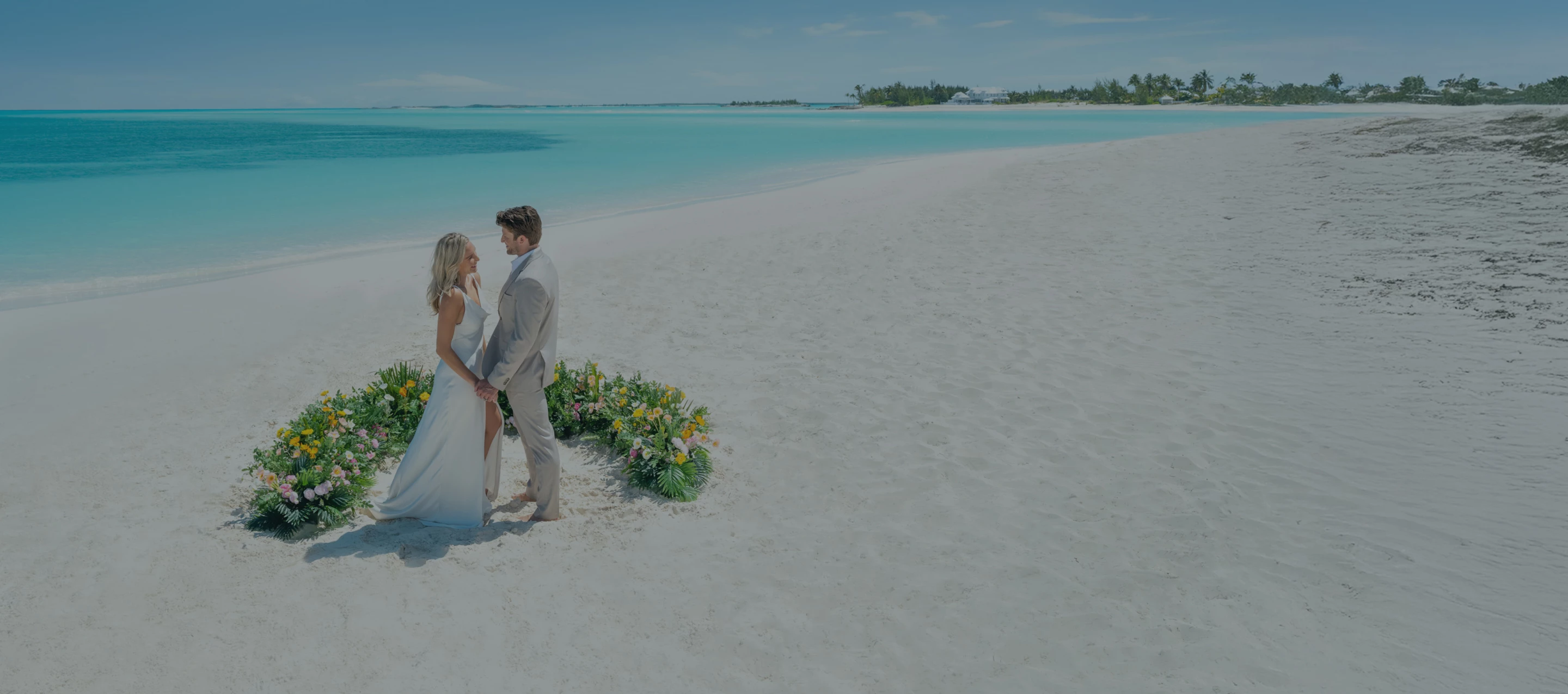 a man and woman standing on a beach