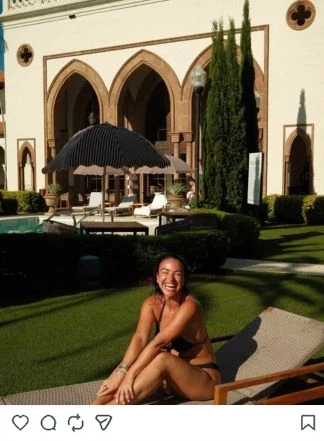 a woman sitting in a chair in front of a building