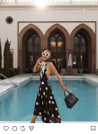 a woman in a dress by a pool