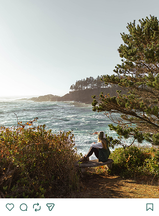 a woman sitting on a bench overlooking a body of water