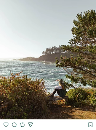 a woman sitting on a bench overlooking a body of water