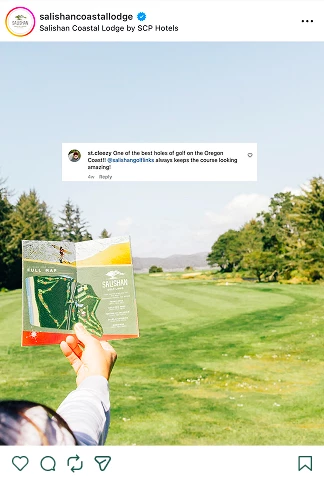 a hand holding a map in front of a golf course