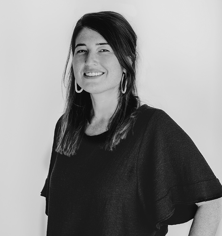 a woman smiling with her hands on her hips