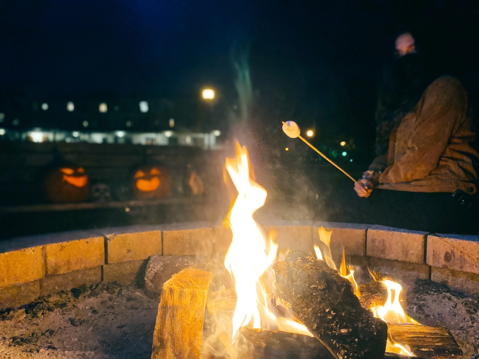 a person roasting marshmallow over a fire