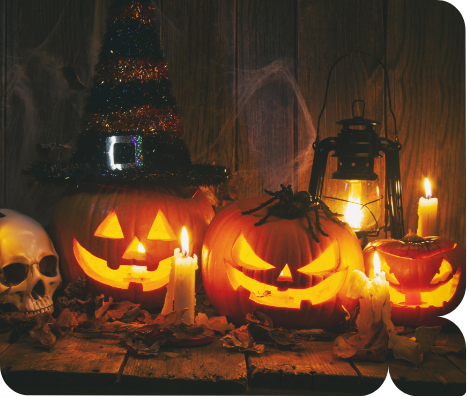 a group of pumpkins with candles and a skull