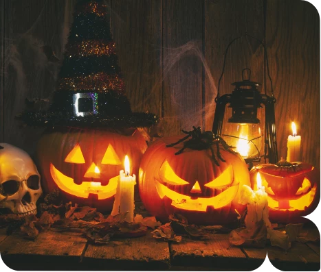 a group of pumpkins with candles and a skull