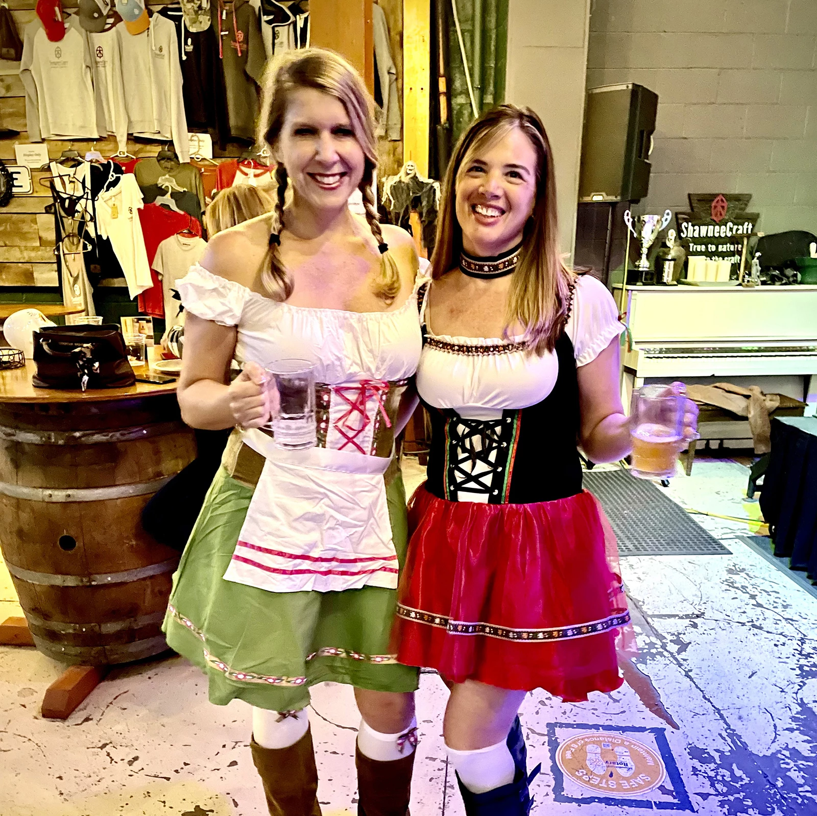 two women in clothing holding drinks