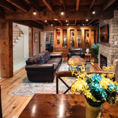 a living room with a brick wall and a couch and a table