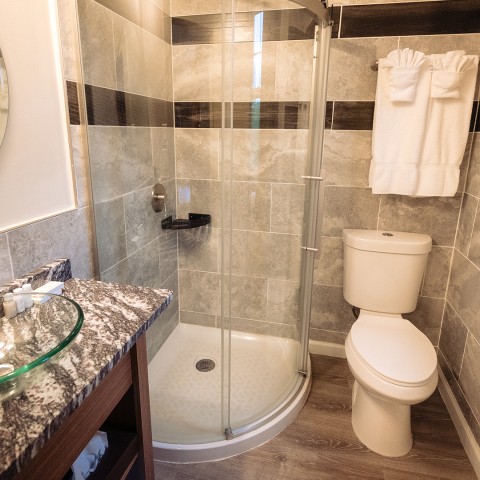 a bathroom with a glass shower and a sink
