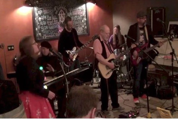 a group of people playing instruments at ShawneeCraft Brewery