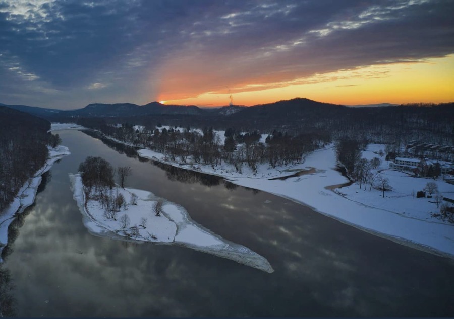 a river with snow and trees