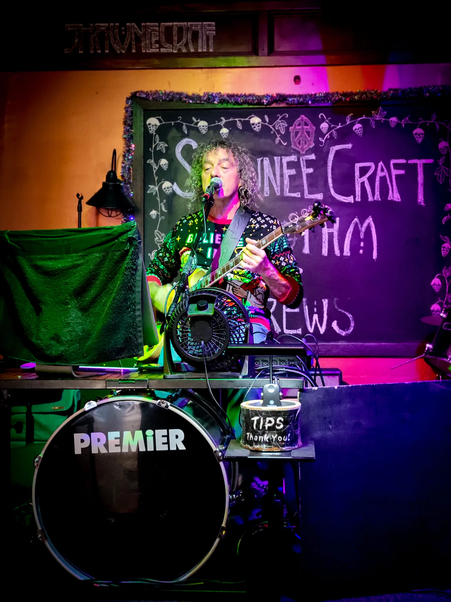 a man playing guitar and singing
