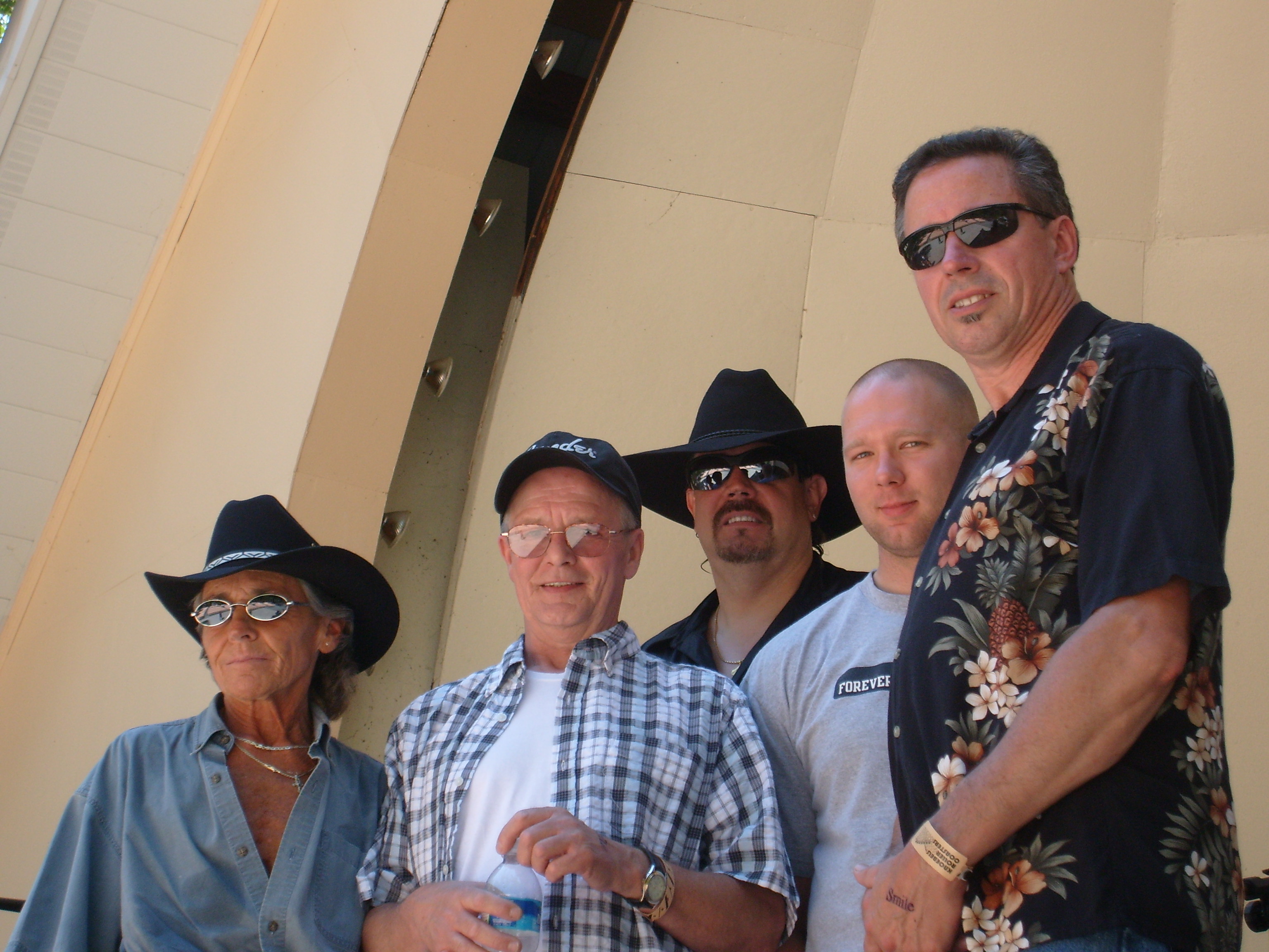 Performers, Len and the sidekicks, wearing cowboy hats and sunglasses