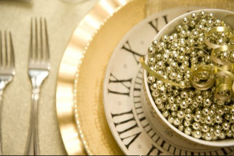 a plate with a clock and a bowl of beads
