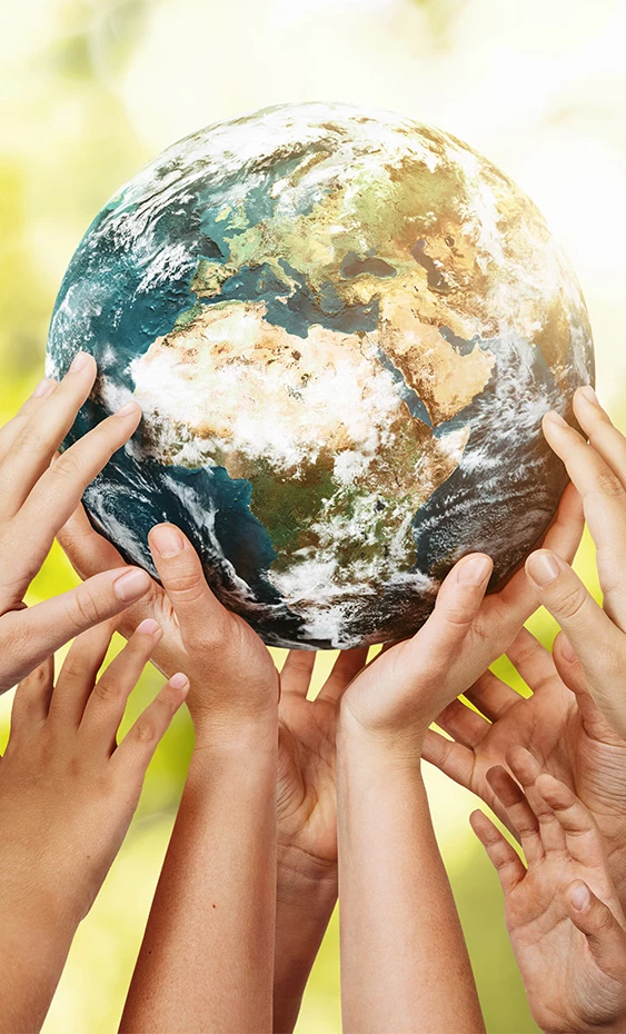 a group of hands holding a planet