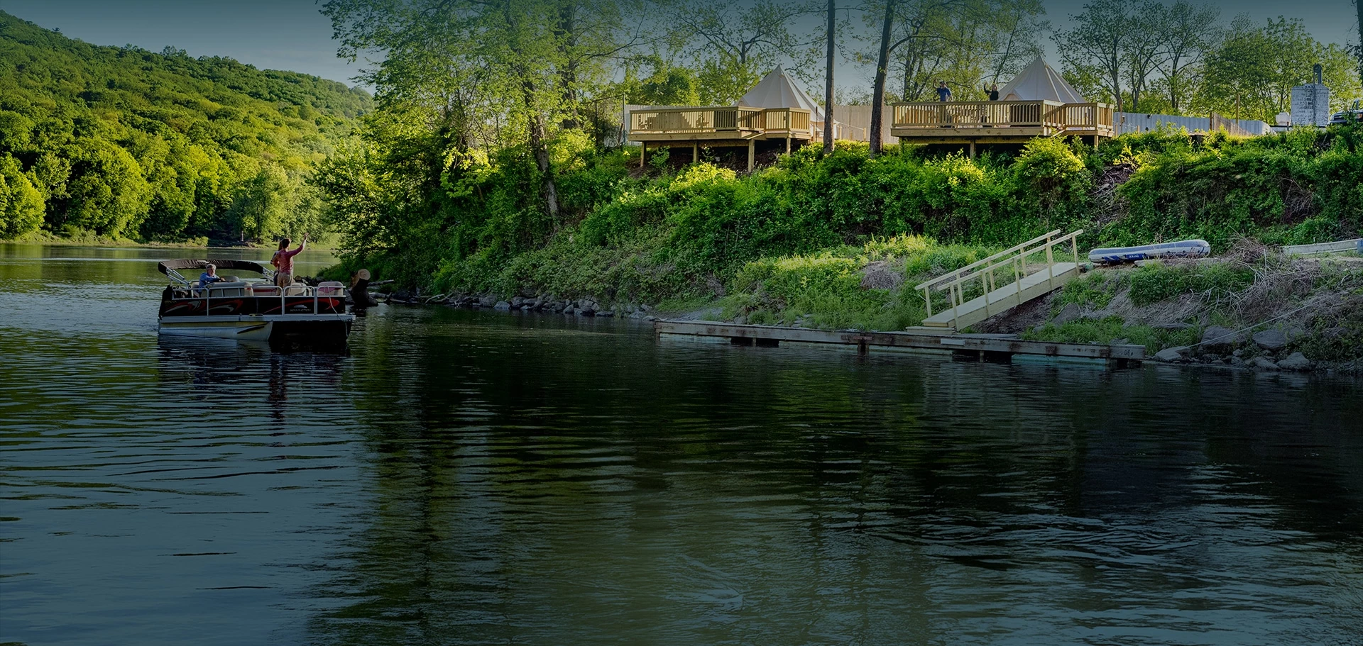 a body of water with a dock and trees