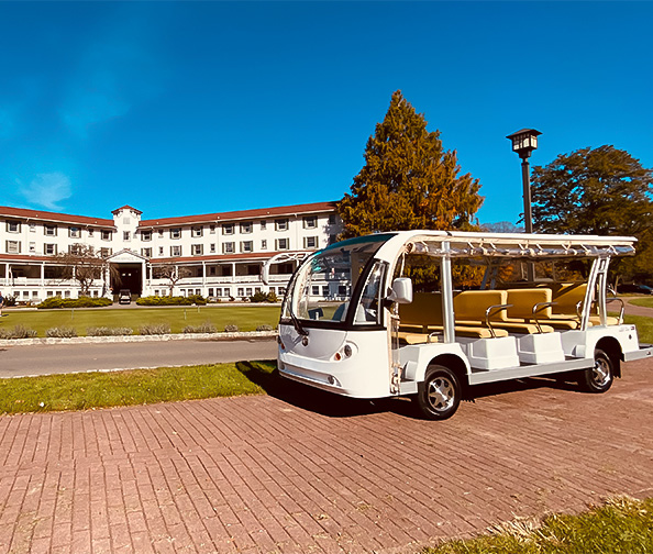 a white bus parked in front of a building