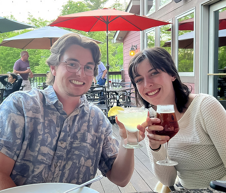 a man and woman holding drinks