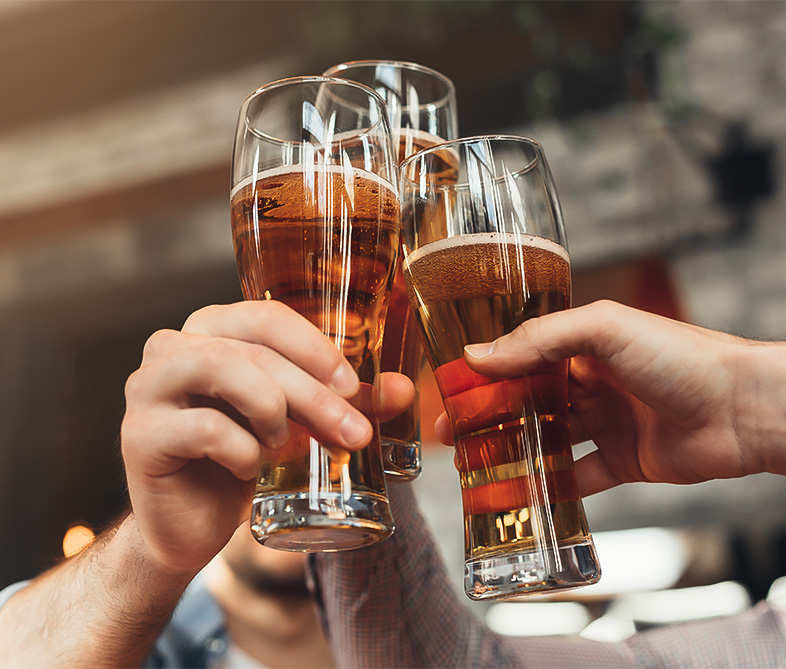 a group of people clinking glasses of beer