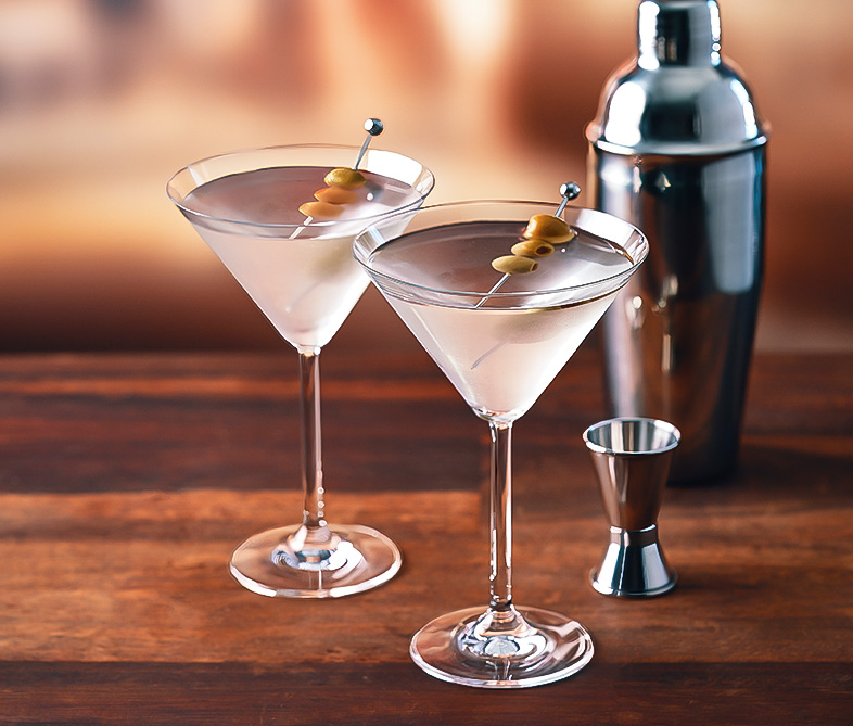 a pair of martini glasses with olives on top