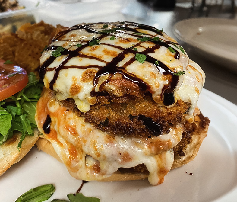 a plate of food with a burger and a side of salad
