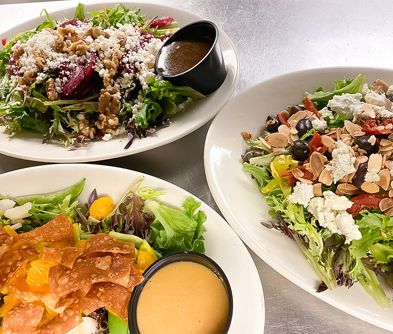 a group of plates of salad