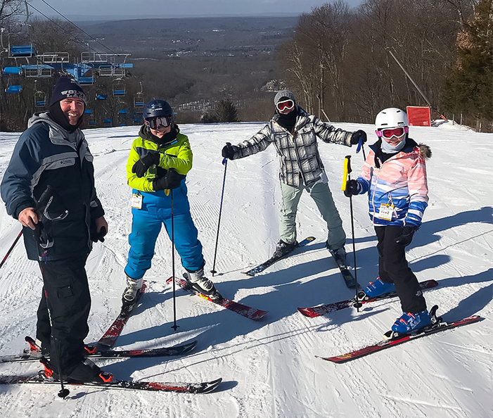 a group of people on skis posing for a picture