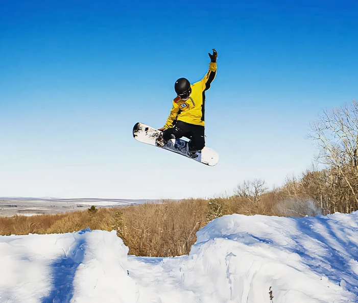 a person jumping on a snowboard